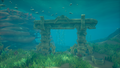An underwater stone archway